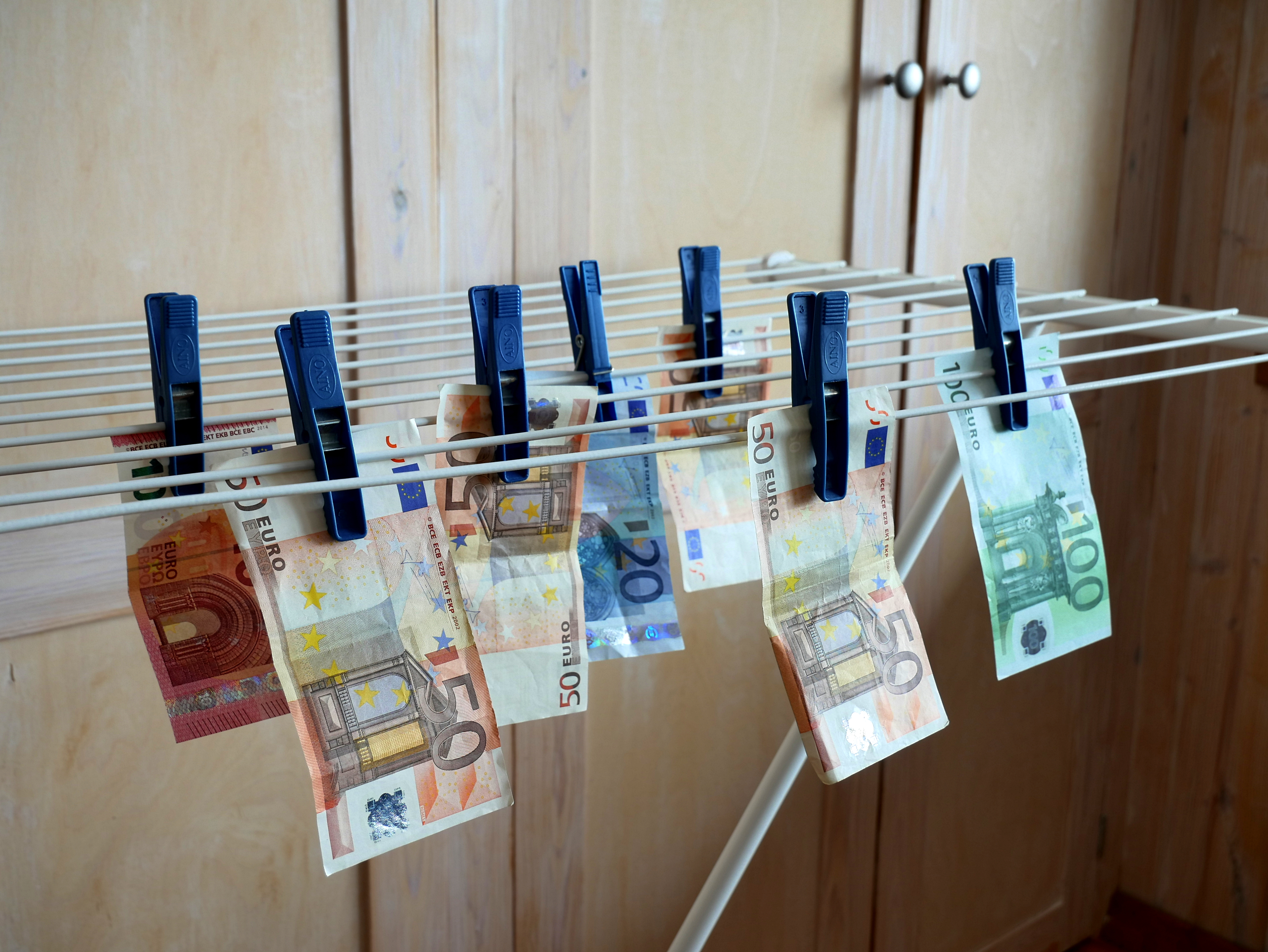 Illustration of money laundering crossed out with a big red X